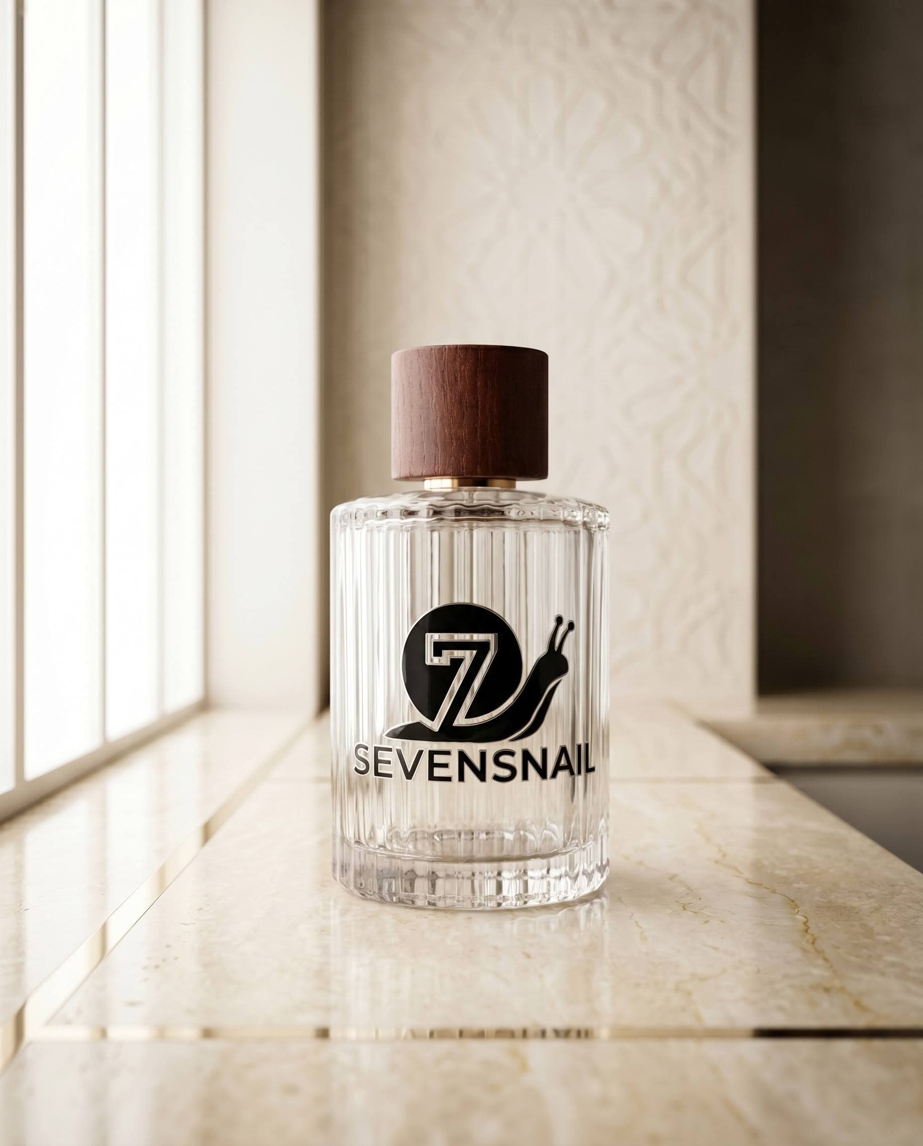 Sevensnail transfer logo applied to a clear perfume bottle