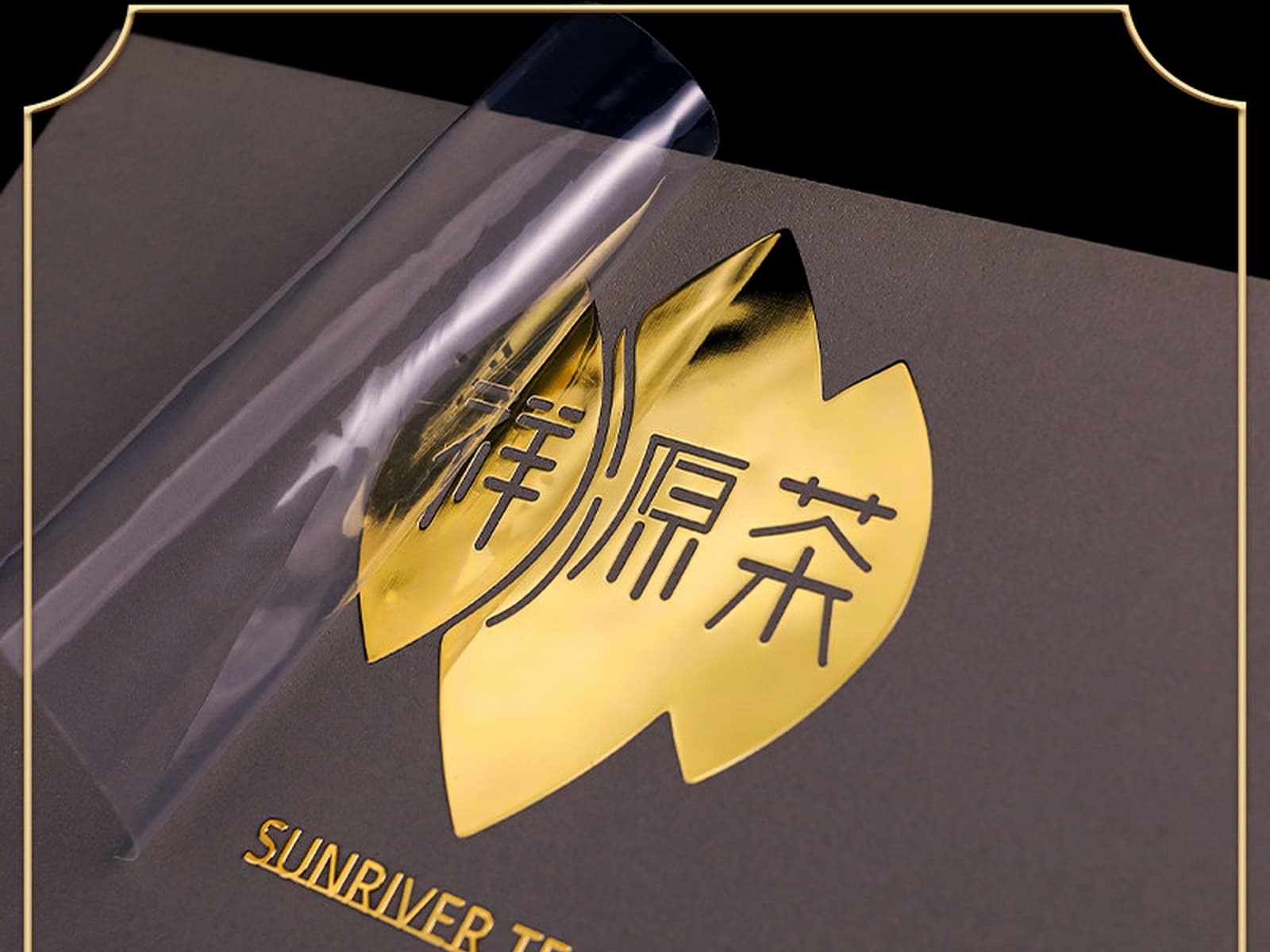 Gold UV transfer film being peeled from a premium logo mark